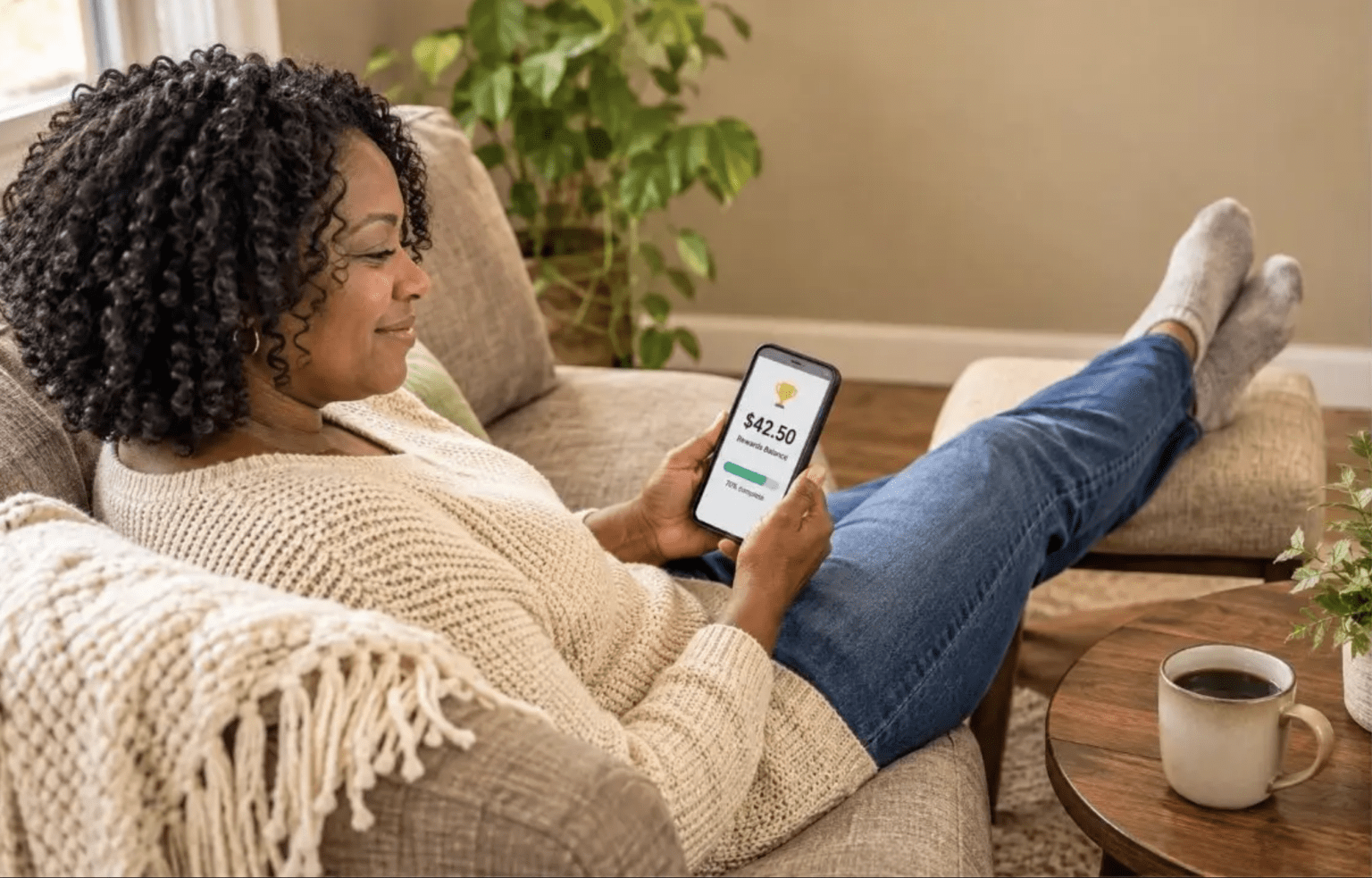 Woman using apps on her mobile phone to earn free gift cards.